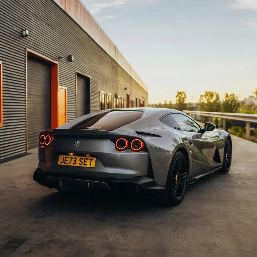 Photo of a gunmetal grey Ferrari 812 Superfast showing the private number plate JE73 SET, which reads as Jet Set and is currently available for sale for £6,450.